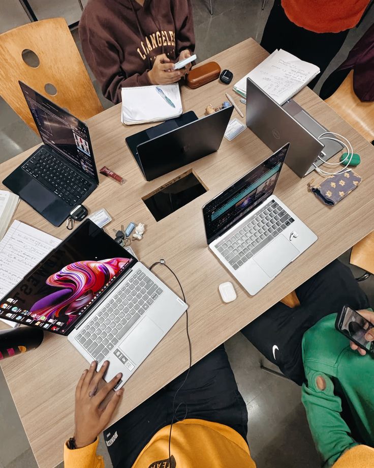 A group working together around laptops at a shared table