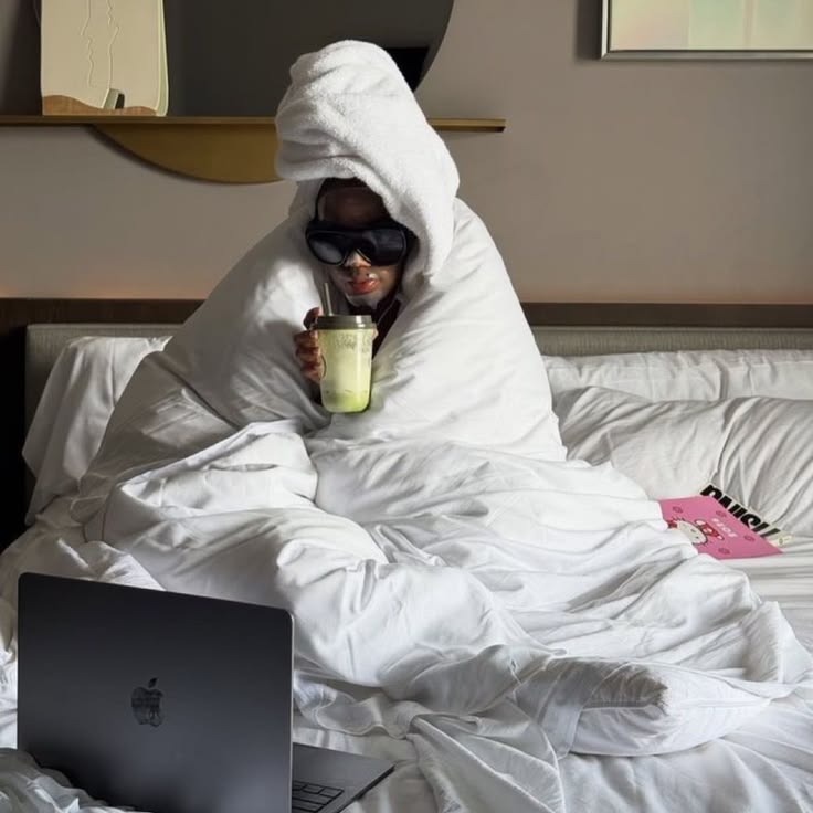 Person in bed with a laptop, scheduling a recurring payment